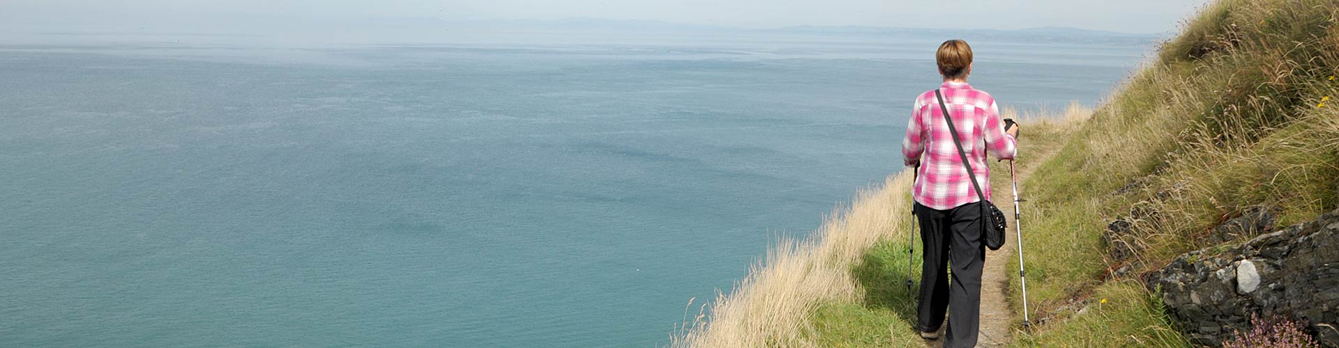 Walker on the cliffs on the Wales Coast Path